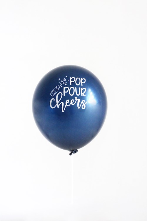 Our Pop Pour Cheers Balloons are metallic navy with white matt ink.