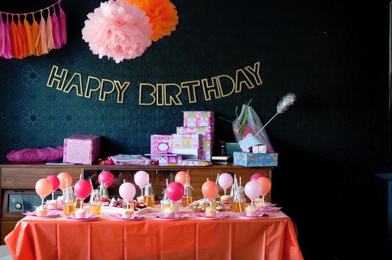 A kids birthday party featuring pink, orange and gold colours.