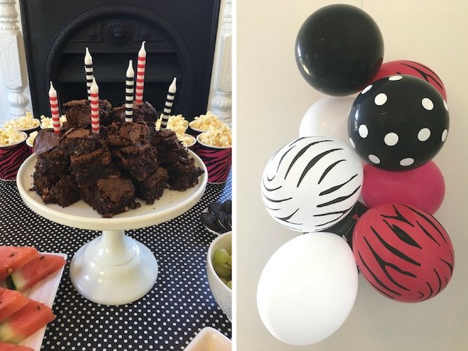 Chocolate browning birthday cake and pink zebra balloons.